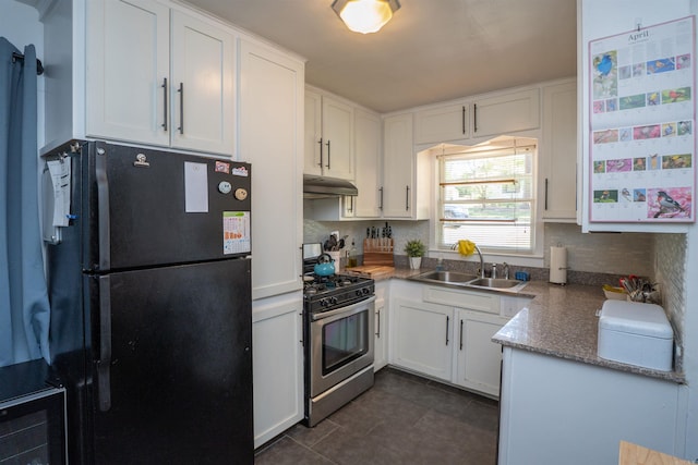 1020 Pine Valley Rd, Little Rock, AR 72207 - kitchen featuring under cabinet range hood, stainless steel gas stove, a sink, freestanding refrigerator, and dark tile patterned floors