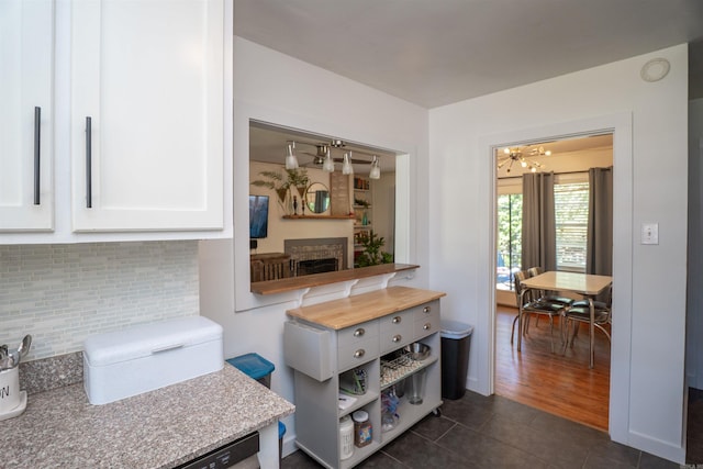1020 Pine Valley Rd, Little Rock, AR 72207 - interior space with backsplash, a chandelier, and a fireplace