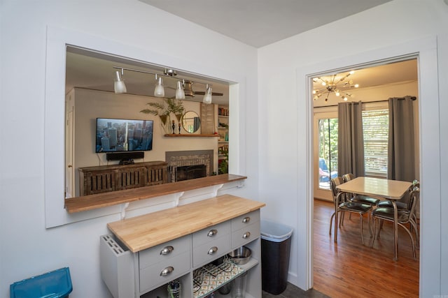 1020 Pine Valley Rd, Little Rock, AR 72207 - room details featuring an inviting chandelier, wood finished floors, and a fireplace