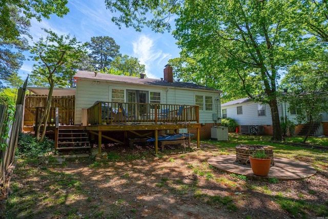 1020 Pine Valley Rd, Little Rock, AR 72207 - rear view of property with a chimney, stairway, a deck, and an outdoor fire pit