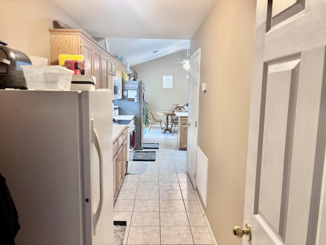 159 Emelia St, Clarksville, AR 72830 - kitchen with lofted ceiling, visible vents, white appliances, light tile patterned flooring, and ceiling fan