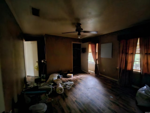 bedroom with baseboards, a ceiling fan, and wood finished floors