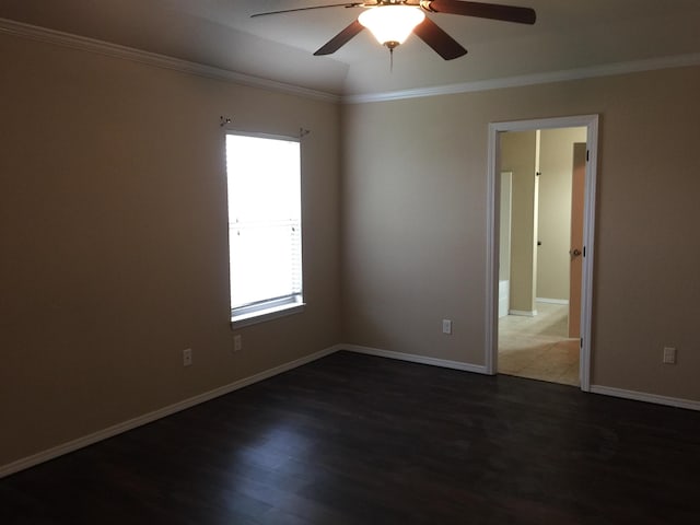 spare room with baseboards, wood finished floors, ceiling fan, and crown molding