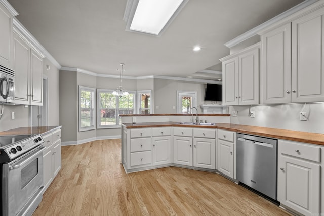 kitchen with white cabinetry, stainless steel appliances, and a sink