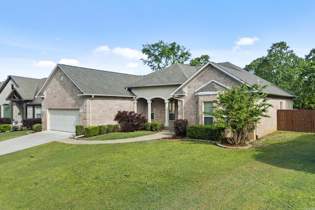 view of front of house with concrete driveway, a shingled roof, fence, a front yard, and brick siding