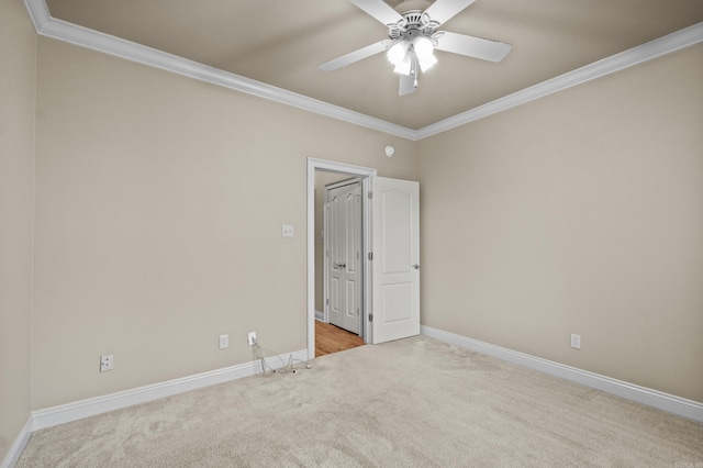 unfurnished room featuring baseboards, a ceiling fan, carpet flooring, and ornamental molding