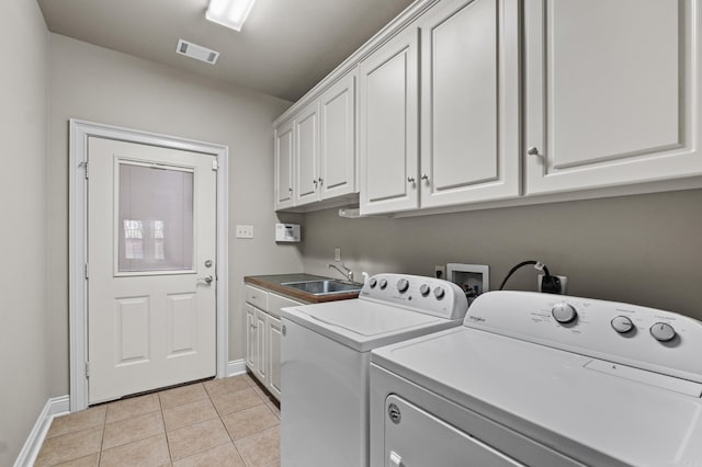 laundry area featuring a sink, separate washer and dryer, light tile patterned floors, cabinet space, and visible vents