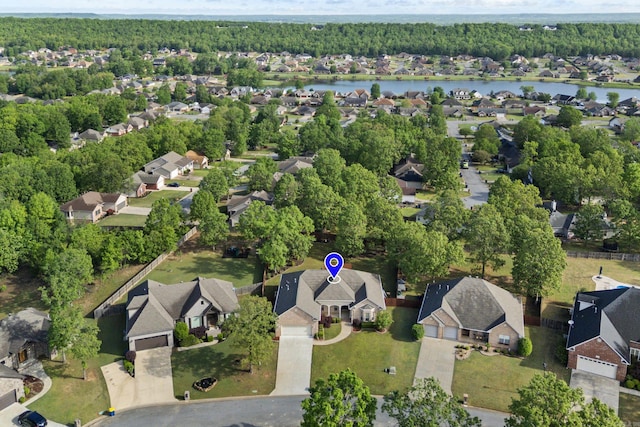 bird's eye view featuring a residential view, a forest view, and a water view