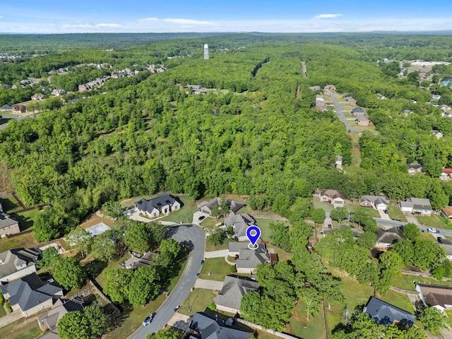 birds eye view of property featuring a residential view and a wooded view