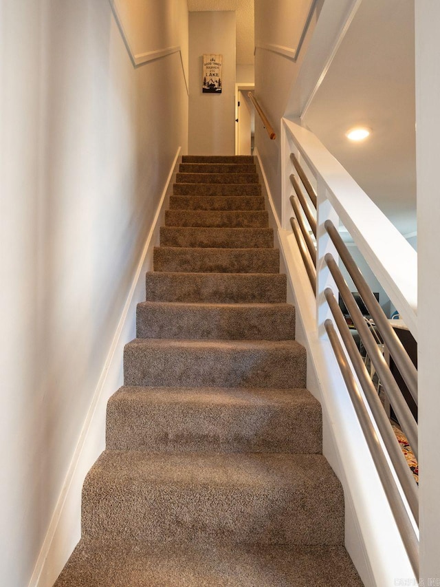 stairs featuring recessed lighting and carpet