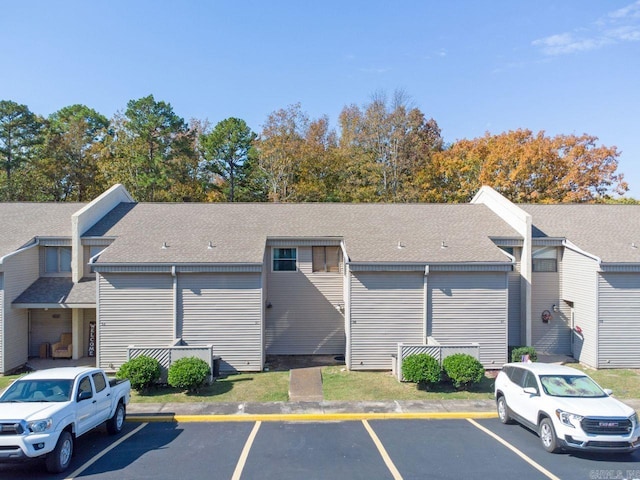 view of property featuring uncovered parking