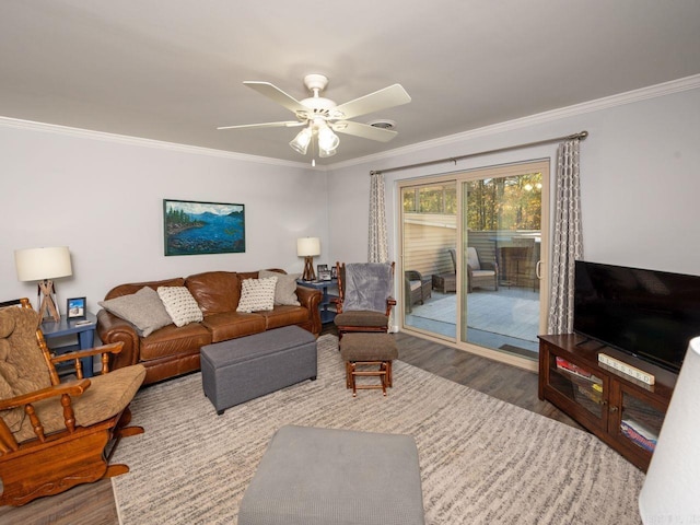 living room with wood finished floors, crown molding, and a ceiling fan