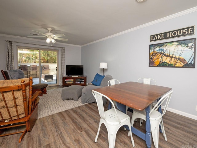 dining room with wood finished floors, a ceiling fan, baseboards, and ornamental molding