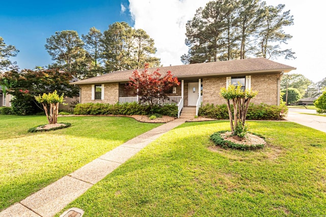 1 Azalea, Magnolia, AR 71753 - ranch-style house with brick siding, a porch, and a front lawn