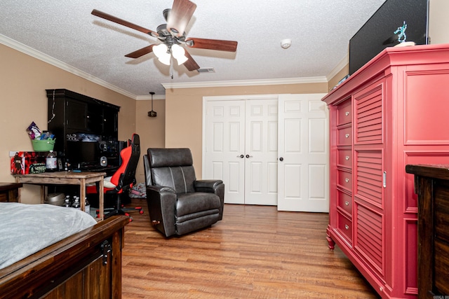 1 Azalea, Magnolia, AR 71753 - bedroom with light wood-style flooring, a textured ceiling, visible vents, ceiling fan, and crown molding