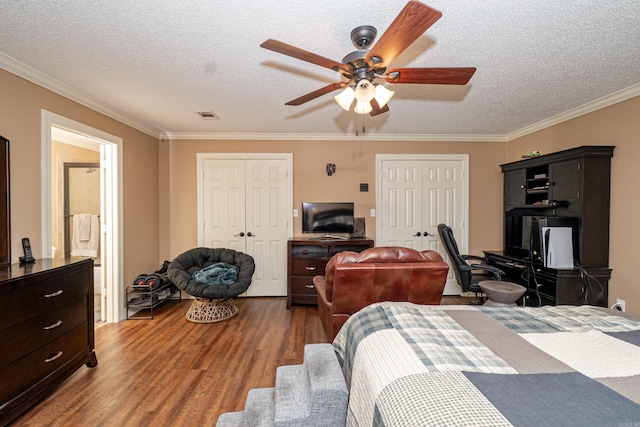 1 Azalea, Magnolia, AR 71753 - bedroom with crown molding, wood finished floors, a textured ceiling, two closets, and visible vents