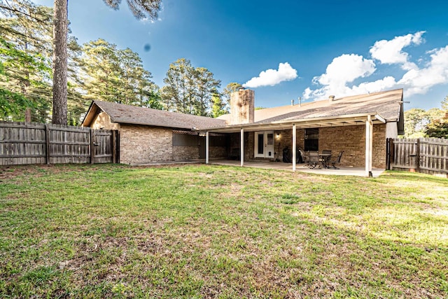 1 Azalea, Magnolia, AR 71753 - rear view of property featuring a lawn, a fenced backyard, a chimney, and brick siding
