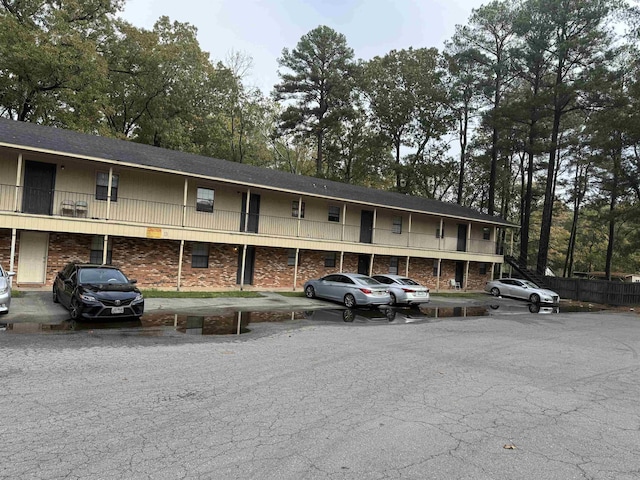 view of building exterior with uncovered parking