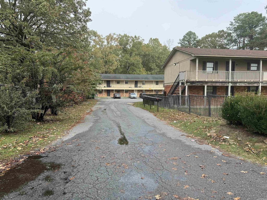 view of road featuring driveway and stairway