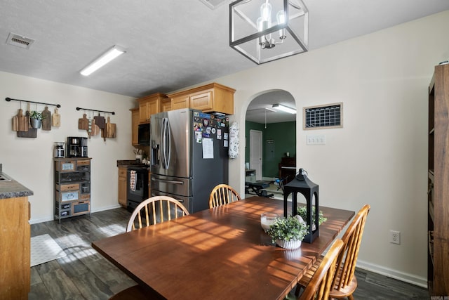 108 Rambler Ln, Rose Bud, AR 72137 - dining area featuring baseboards, visible vents, arched walkways, and dark wood finished floors