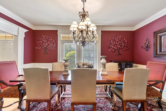 dining space featuring ornamental molding and an inviting chandelier