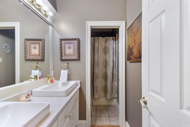 full bathroom featuring tile patterned flooring, a sink, and double vanity