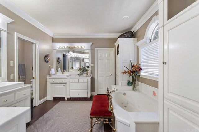 full bath featuring a jetted tub, crown molding, and vanity