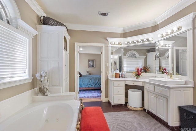 ensuite bathroom featuring a tub with jets, crown molding, vanity, and visible vents