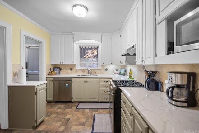 kitchen with a sink, stainless steel appliances, white cabinetry, backsplash, and under cabinet range hood
