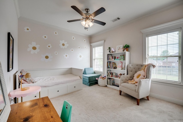 sitting room with ceiling fan, carpet floors, a healthy amount of sunlight, and crown molding