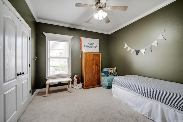 bedroom featuring carpet floors, crown molding, baseboards, and a ceiling fan