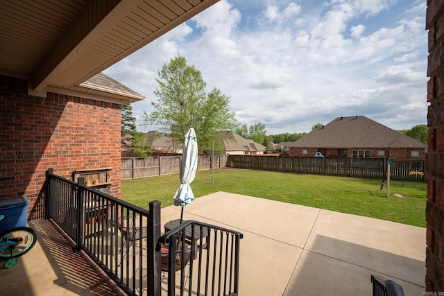 view of patio / terrace with a fenced backyard and a fireplace