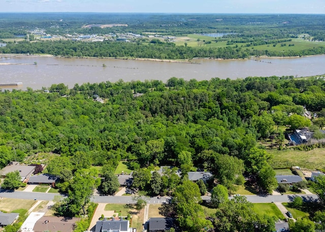 birds eye view of property featuring a forest view and a water view