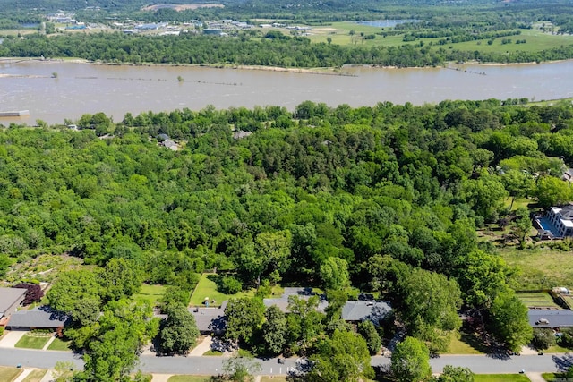 drone / aerial view featuring a view of trees and a water view