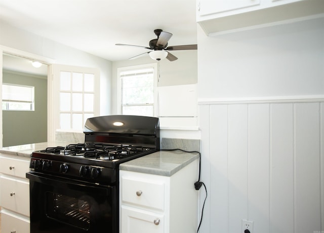 2602 S Taylor St, Little Rock, AR 72204 - kitchen with black range with gas stovetop, plenty of natural light, ceiling fan, and wainscoting