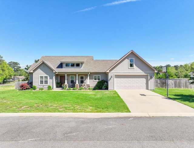 view of front facade featuring fence, a porch, driveway, and a front yard