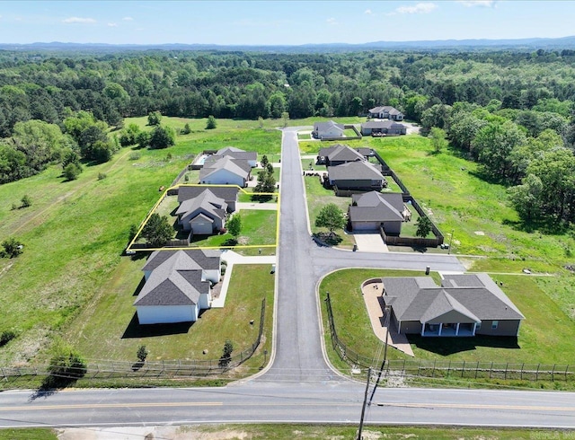 drone / aerial view featuring a view of trees and a residential view