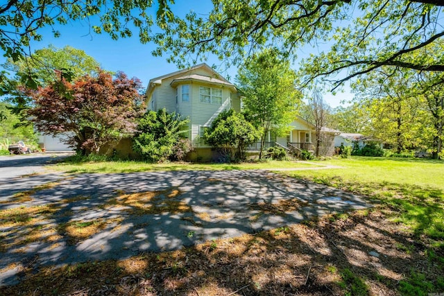 view of property exterior featuring a lawn