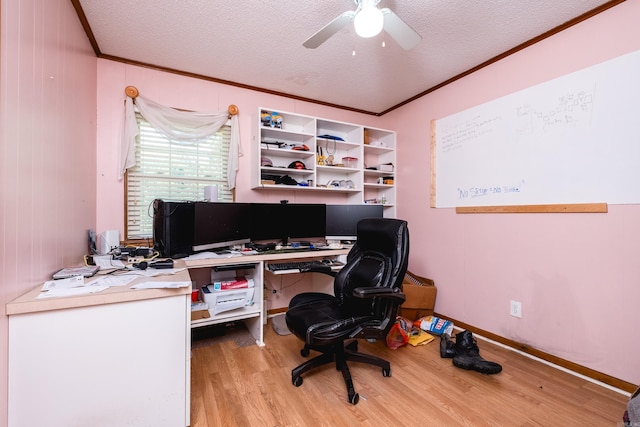 office with ceiling fan, crown molding, wood finished floors, and a textured ceiling