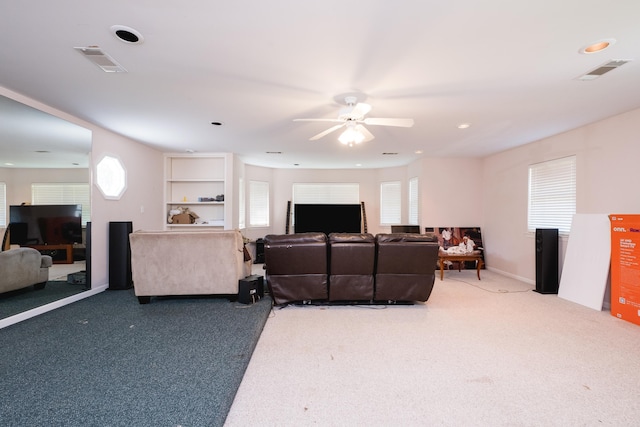 carpeted living room with a ceiling fan, visible vents, and recessed lighting
