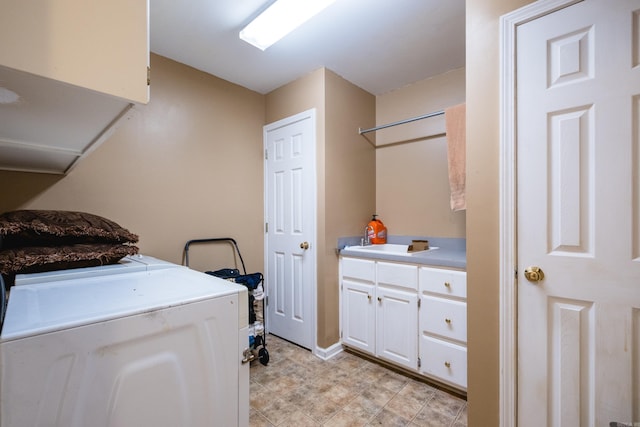 laundry area featuring washing machine and dryer and cabinet space