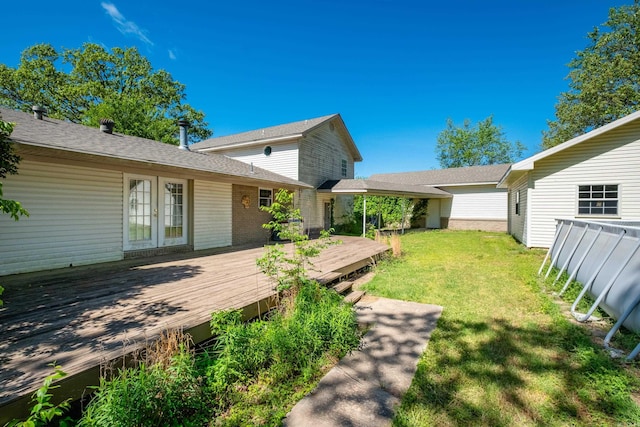 view of yard with a wooden deck and french doors