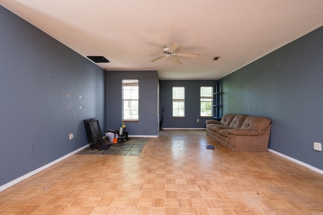 unfurnished room featuring visible vents, baseboards, and ceiling fan
