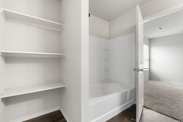 4472 Olympic, Benton, AR 72019 - bathroom with wood finished floors, visible vents, baseboards, and shower / tub combination