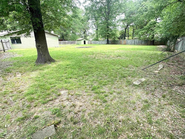 view of yard featuring a shed and an outbuilding