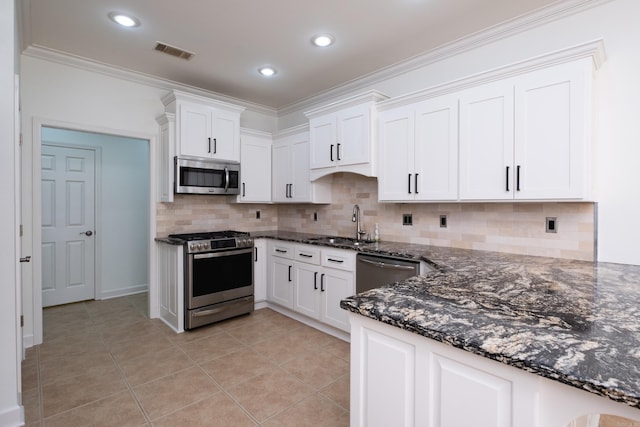 131 Hidden Valley Loop, Maumelle, AR 72113 - kitchen with visible vents, dark stone counters, stainless steel appliances, and a sink