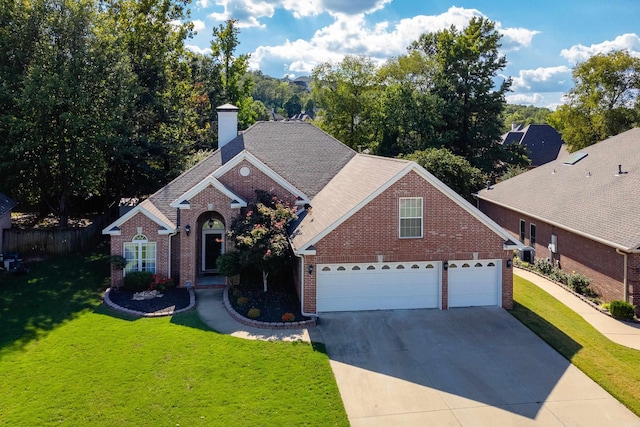 131 Hidden Valley Loop, Maumelle, AR 72113 - view of front facade with brick siding, an attached garage, driveway, and a front yard