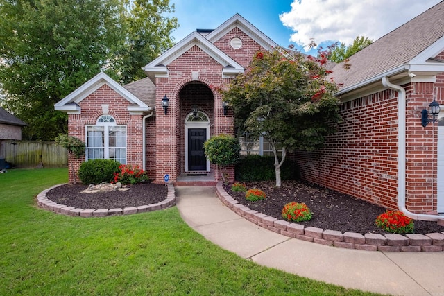 131 Hidden Valley Loop, Maumelle, AR 72113 - view of front of property with fence, brick siding, a front yard, and roof with shingles