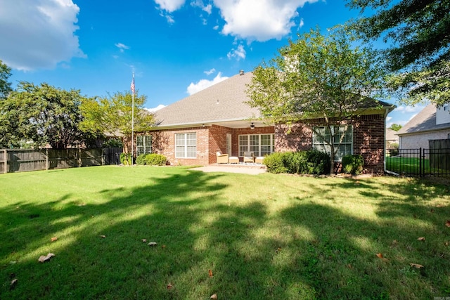 131 Hidden Valley Loop, Maumelle, AR 72113 - back of house with a fenced backyard, a yard, ceiling fan, a patio, and brick siding