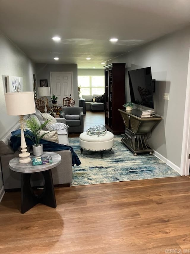 living room featuring recessed lighting, wood finished floors, and baseboards